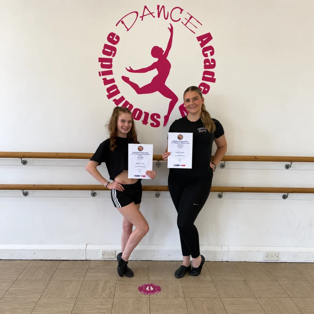 Two Stourbridge Dance Academy students holding their Student Freestyle Teachers examination certificates